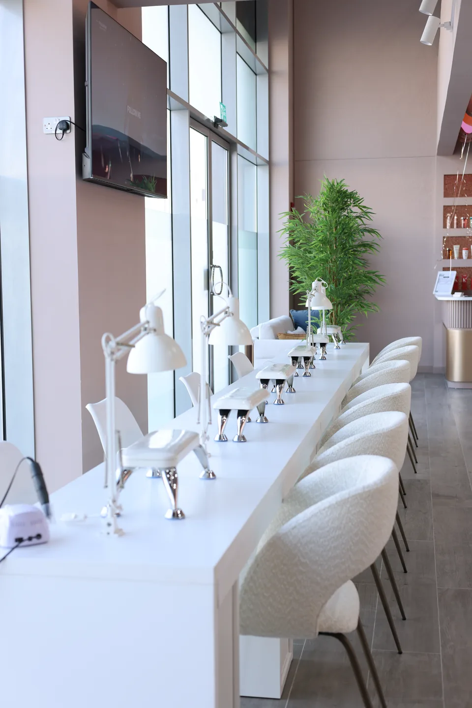 Empty manicure stations beside the windows at Beauty Airways