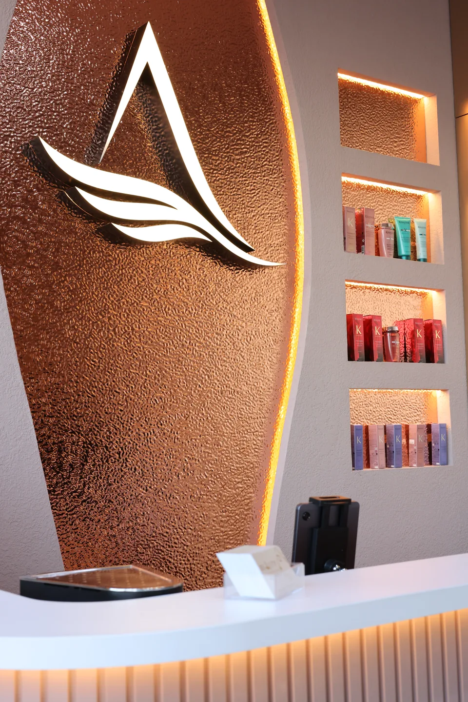 Beauty Airways emblem on the illuminated bronze reception wall